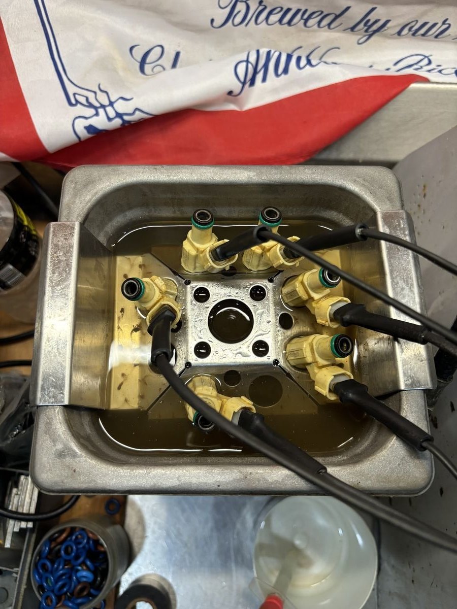 Fuel injectors in ultrasonic cleaning bath